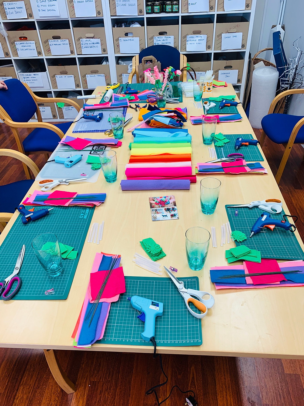 A table laid with felt and tools to make felt flowers