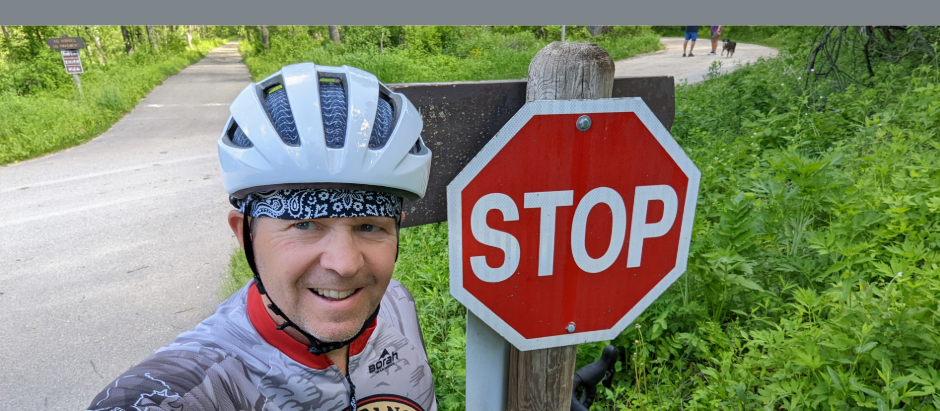 Bicyclist at a stop sign near an intersection