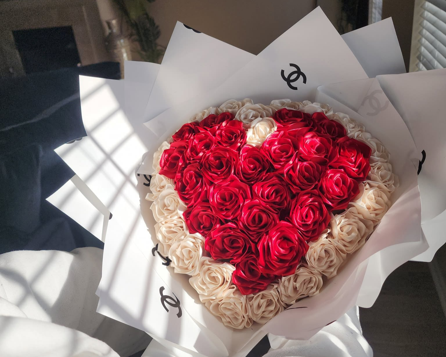 A florist meticulously crafting a custom hand-tied bouquet with delicate textures.