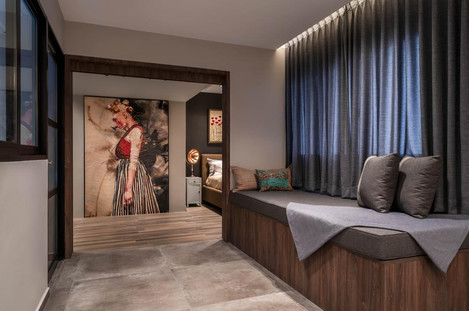 Modern bedroom design with wooden accents, large closet, and warm-toned decor.

