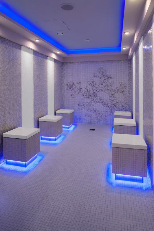 Cold room in a cruise ship thermal spa aboard Celebrity Reflection with stone seating and soft blue ambient lighting