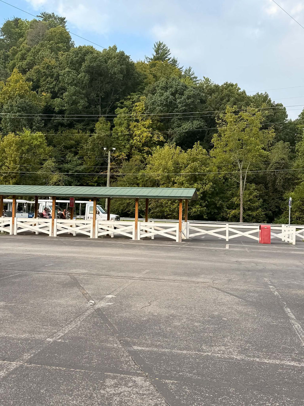 Dollywood parking lot tram stop with covered pickup area near the theme park in Pigeon Forge, Tennessee.
