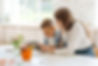 woman teacher reading with elementary age boy in classroom