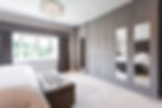 floor to ceiling fitted hand painted wardrobes with oak interiors