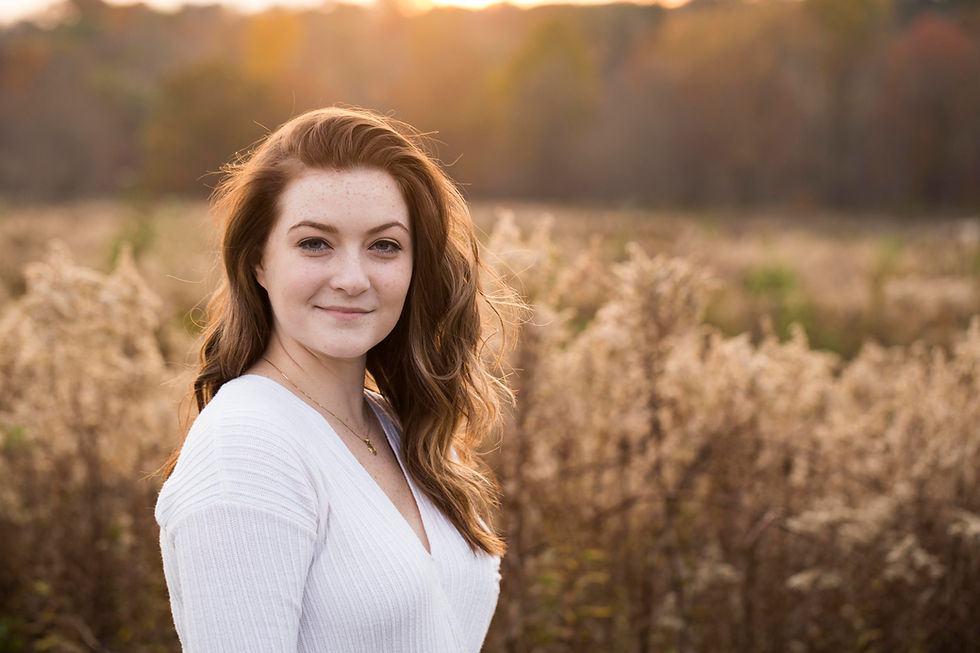 RAW photo of high school senior natural light portrait during golden hour in field of grass