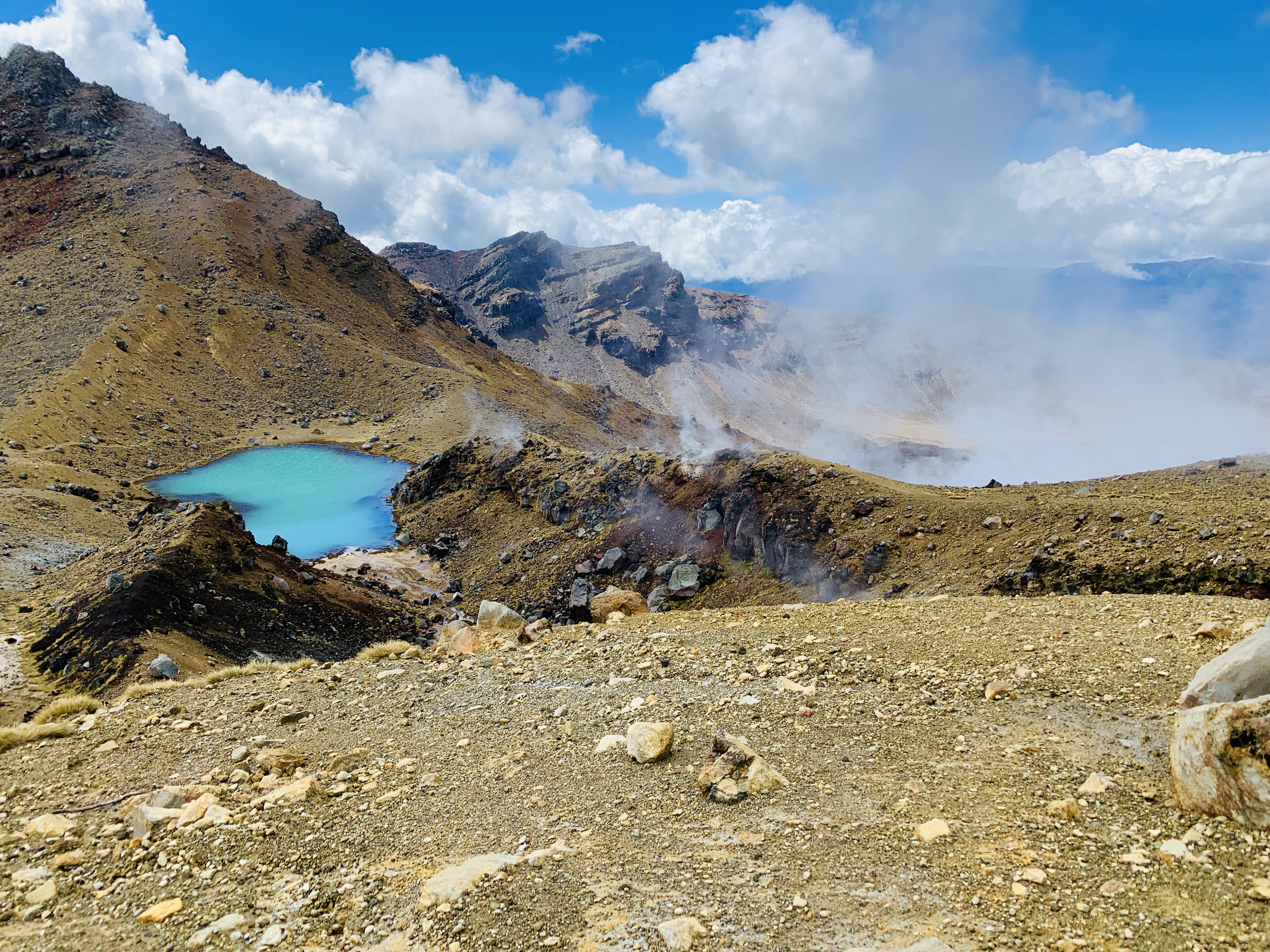Steam vents and geothermal activity on the right