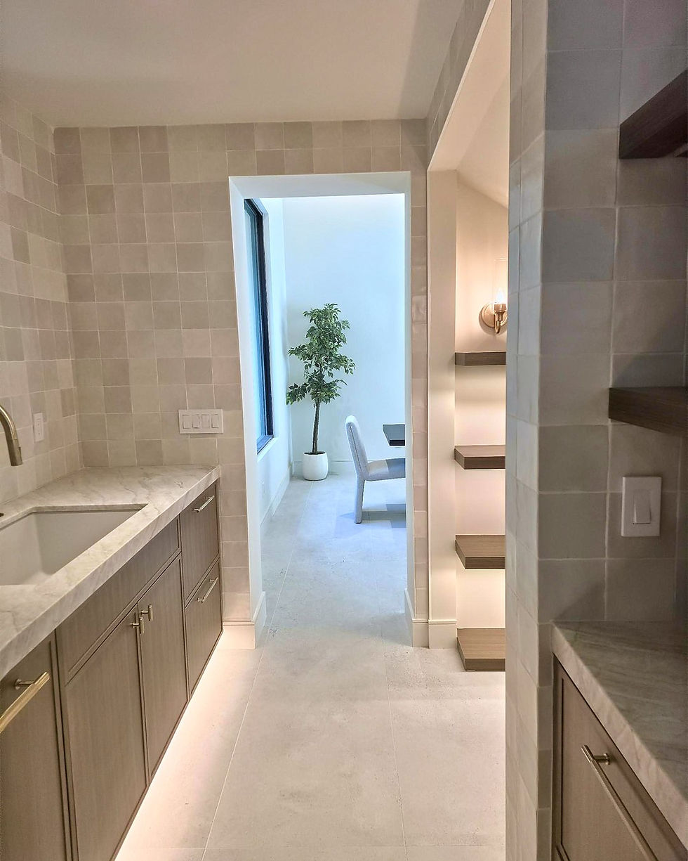 Scullery with square tile walls, a second sink and floating wood shelves