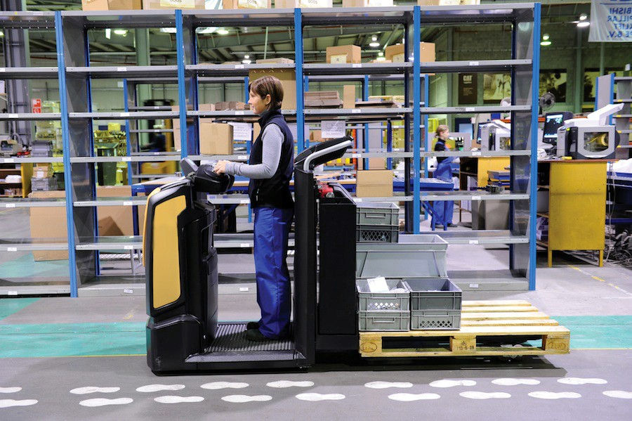 Order Picking Forklift Truck driving through a warehouse