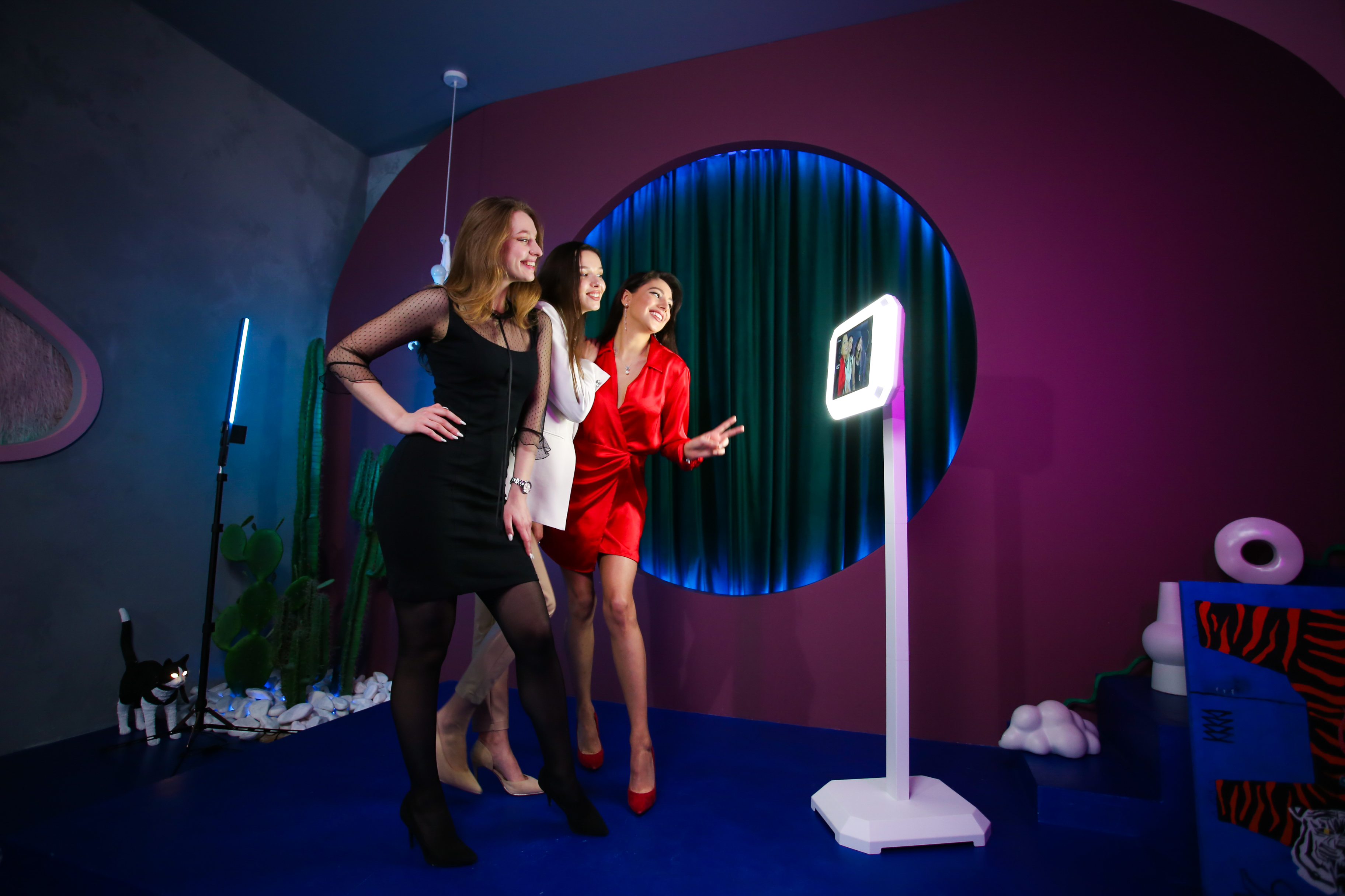 Corporate guests posing beside an interactive photo booth