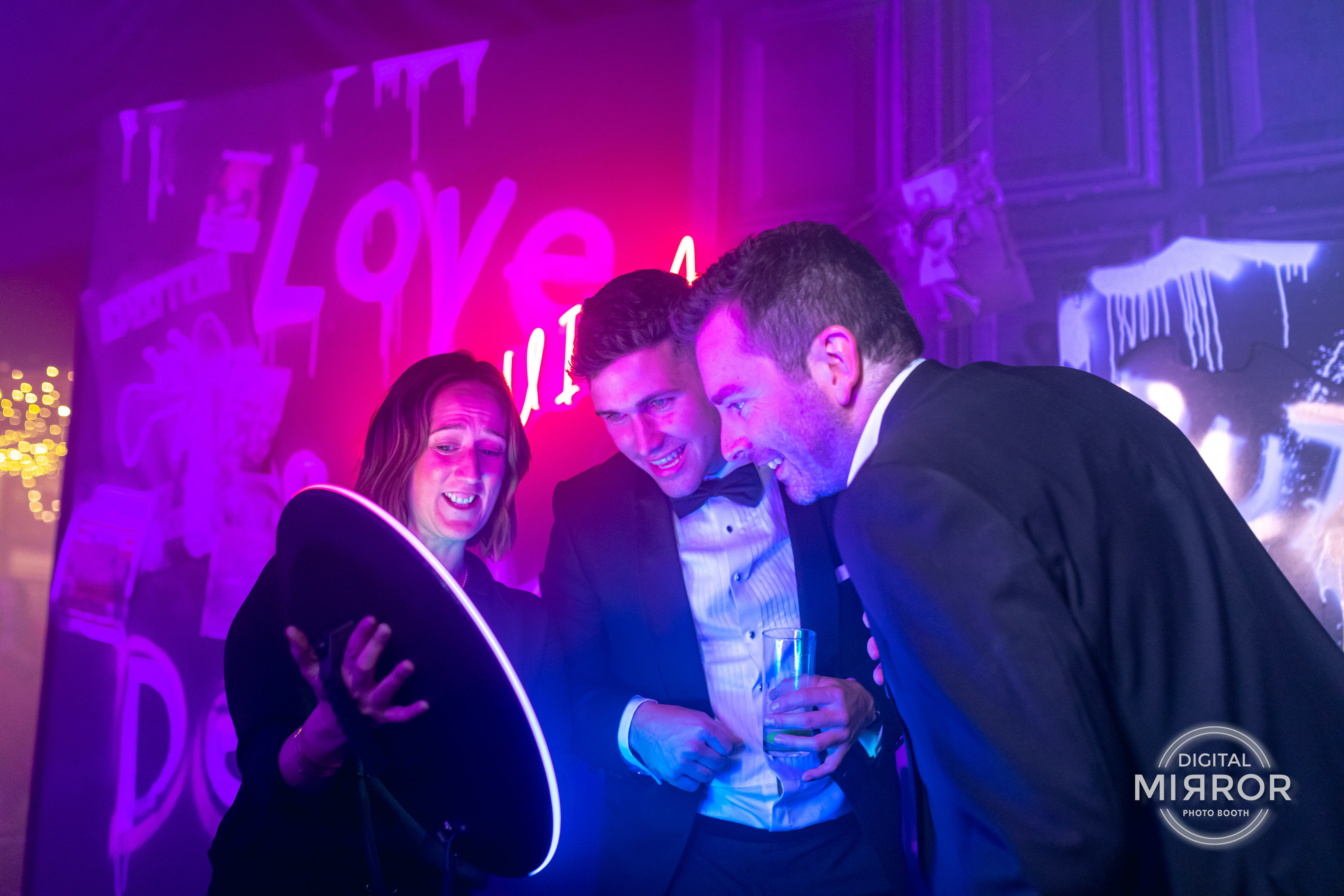 Guests using a DMA interactive photo booth at a corporate gala.
