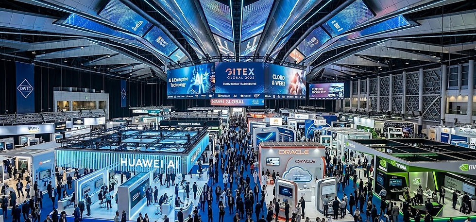 Wide aerial view of a bustling tech conference floor with branded booths and massive LED screens. Professional event marketing ideas and corporate activations by DMA.