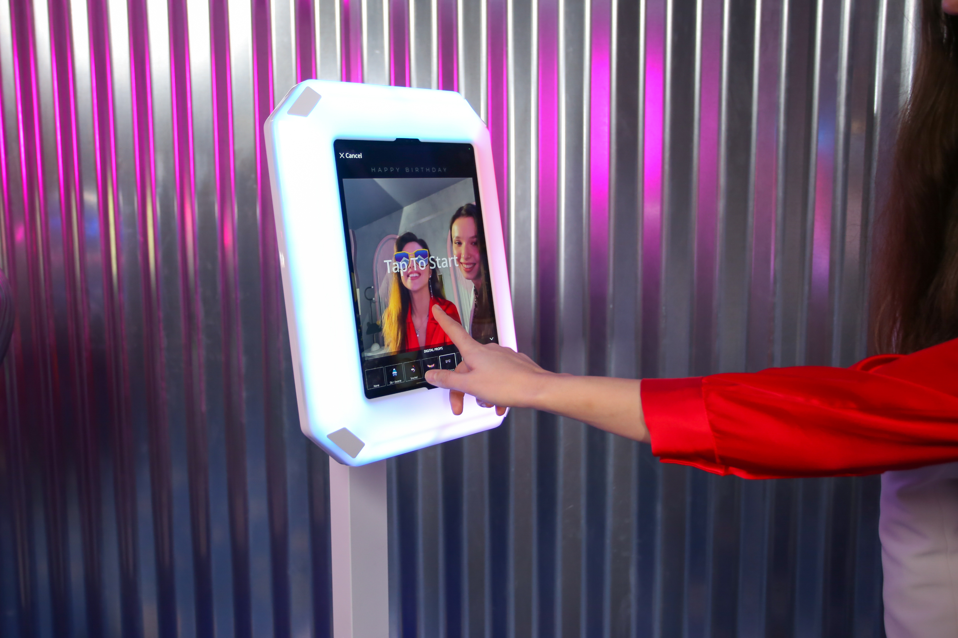 Guest using a DMA photo booth touchscreen.