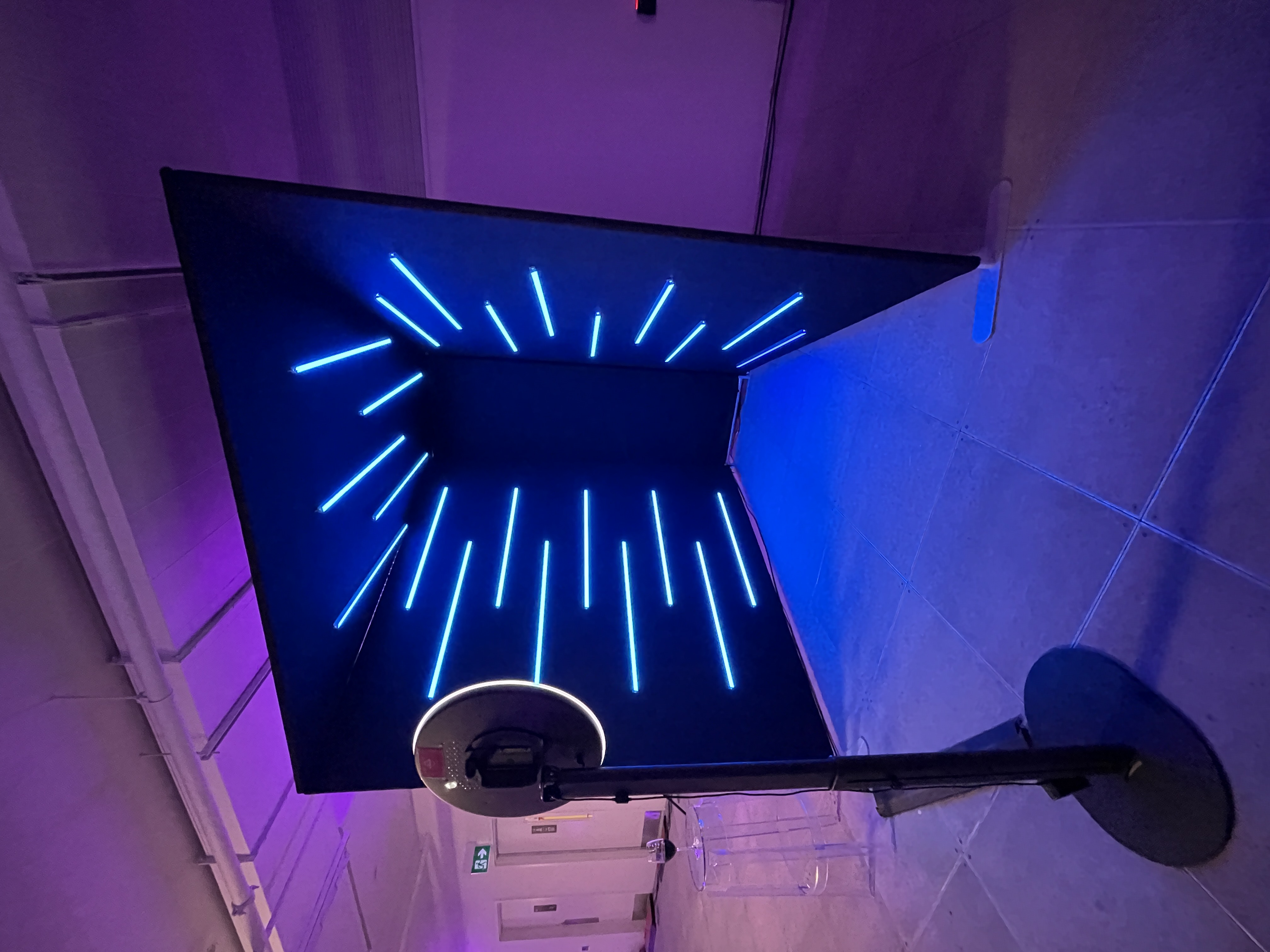 Immersive DMA event installation with blue lighting.