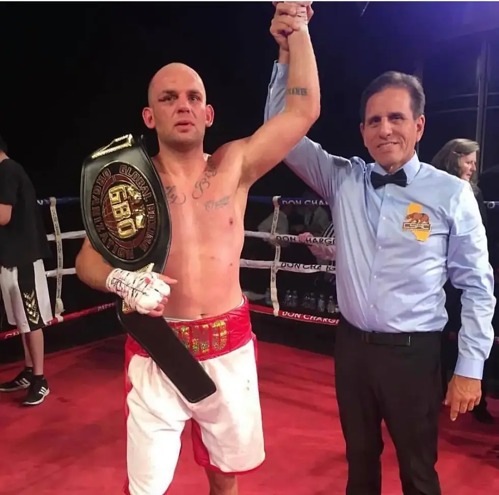 Ryan Bourland in the ring, proudly holding his boxing belt, embodying determination and posing the question of whether he can be the one to stop Jake Paul's momentum in boxing.