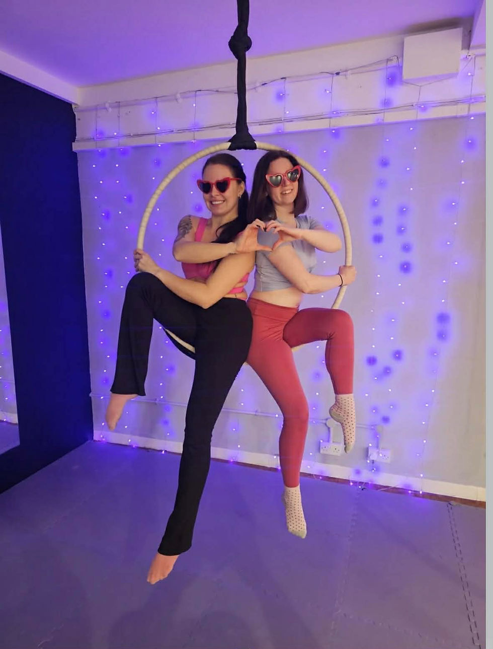 Close-up view of a person gripping an aerial hoop during a workout