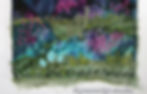 close up of meadow of textile art fabric hand embroidery landscape with mountain and clouds in the sky