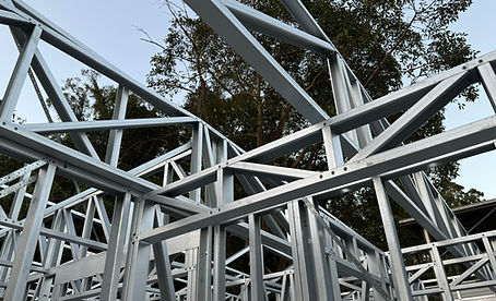 Steel frame construction, building structure, metal beams, against the sky, supports the house.