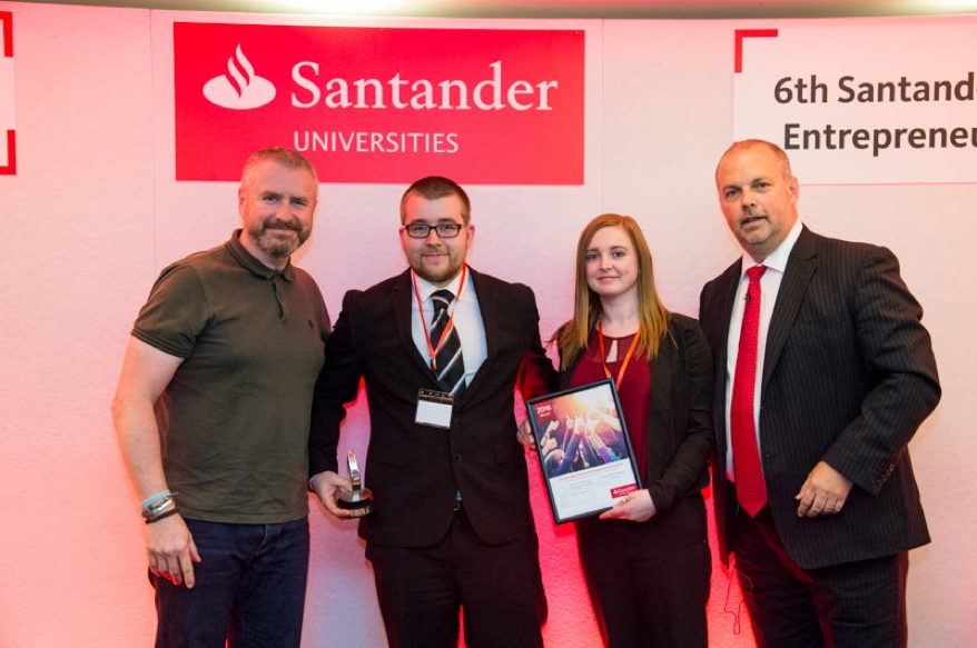Michael McLeod, supported by his fiancée, receiving the winners trophy and £15,000 cash prize.