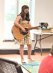 Flora Nye, children's musician and business owner, plays guitar at Warren County Public Library- Lisa Rice Branch in BGKY