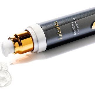 a grey serum bottle laid sideways, revealing its clear, jelly-like serum content inside
