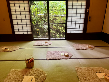soft fluffy mats placed on tatami floors in a traditional Japanese room with shoji windows in the background