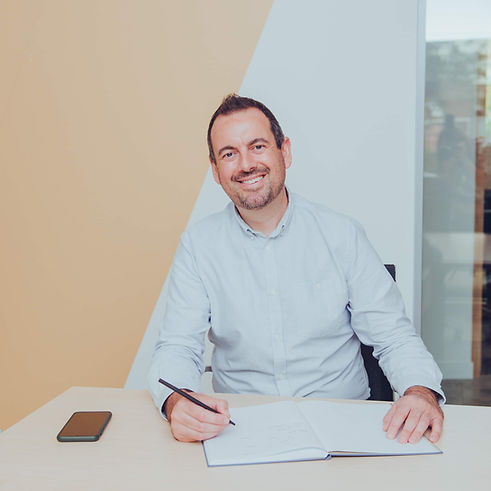 Liam Donovan Will Writer sitting at his desk with an approachable smile