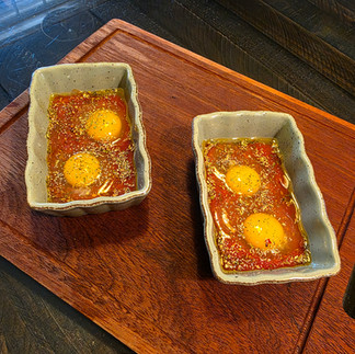 Two Dishes with Eggs on top of the tomato base
