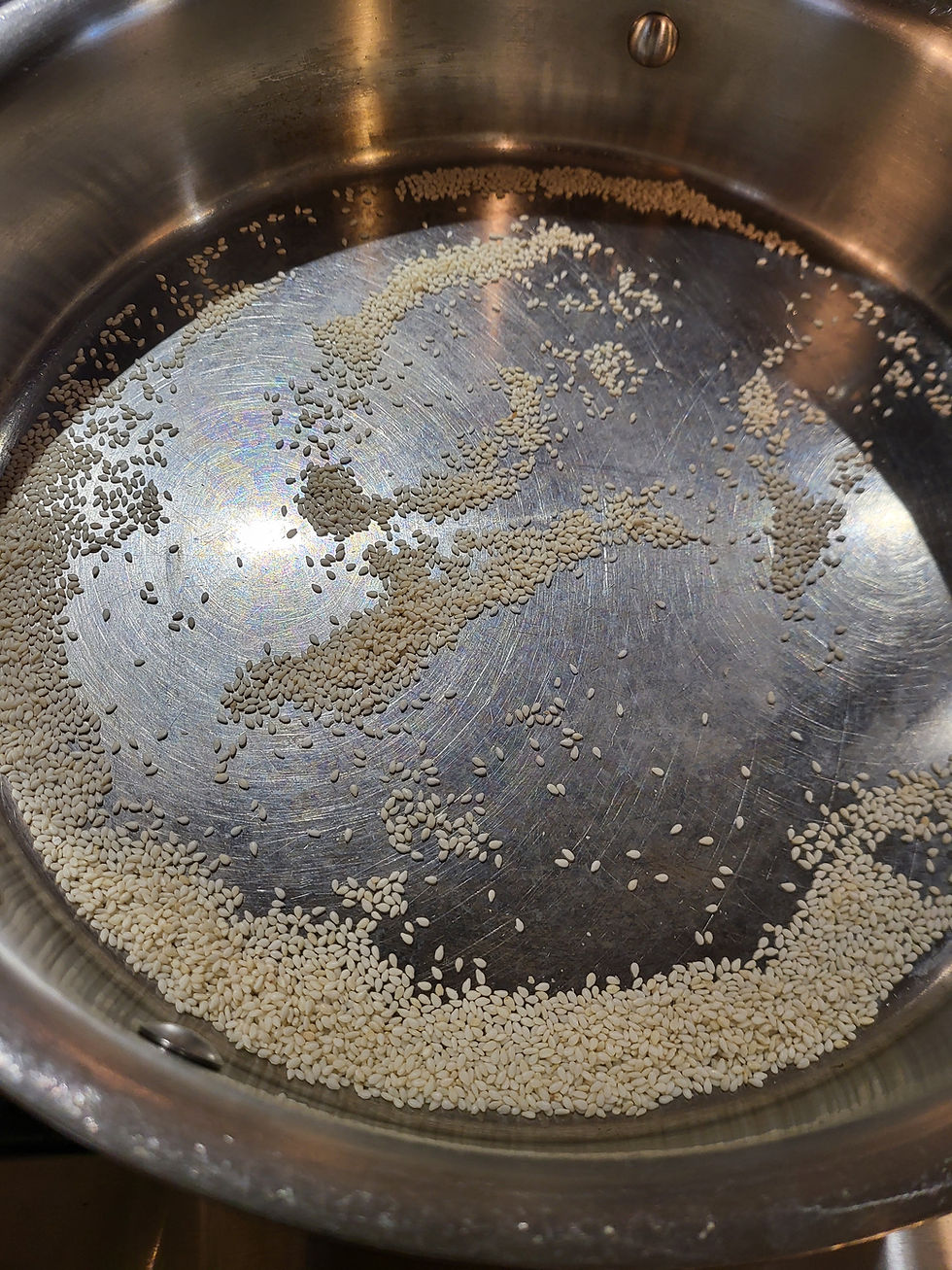 Sesame seeds toasting in a hot pan