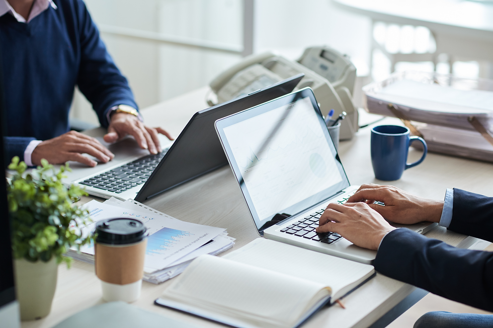 Business professionals at a shared desk, illustrating how to find family office investors.