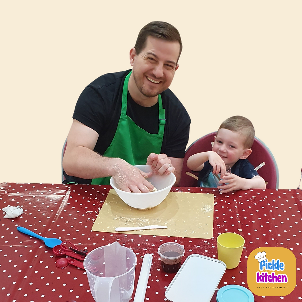 A father and son taking part in a family food workshop, making pastry.