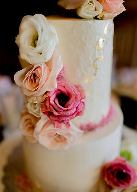 Pink and white wedding cake with flowers