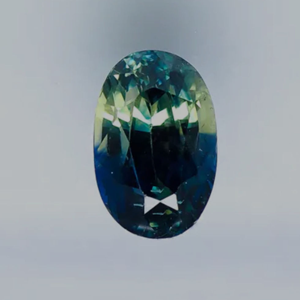 loose oval bi colour sapphire parti sapphire showing blur green and yellow colour zoning