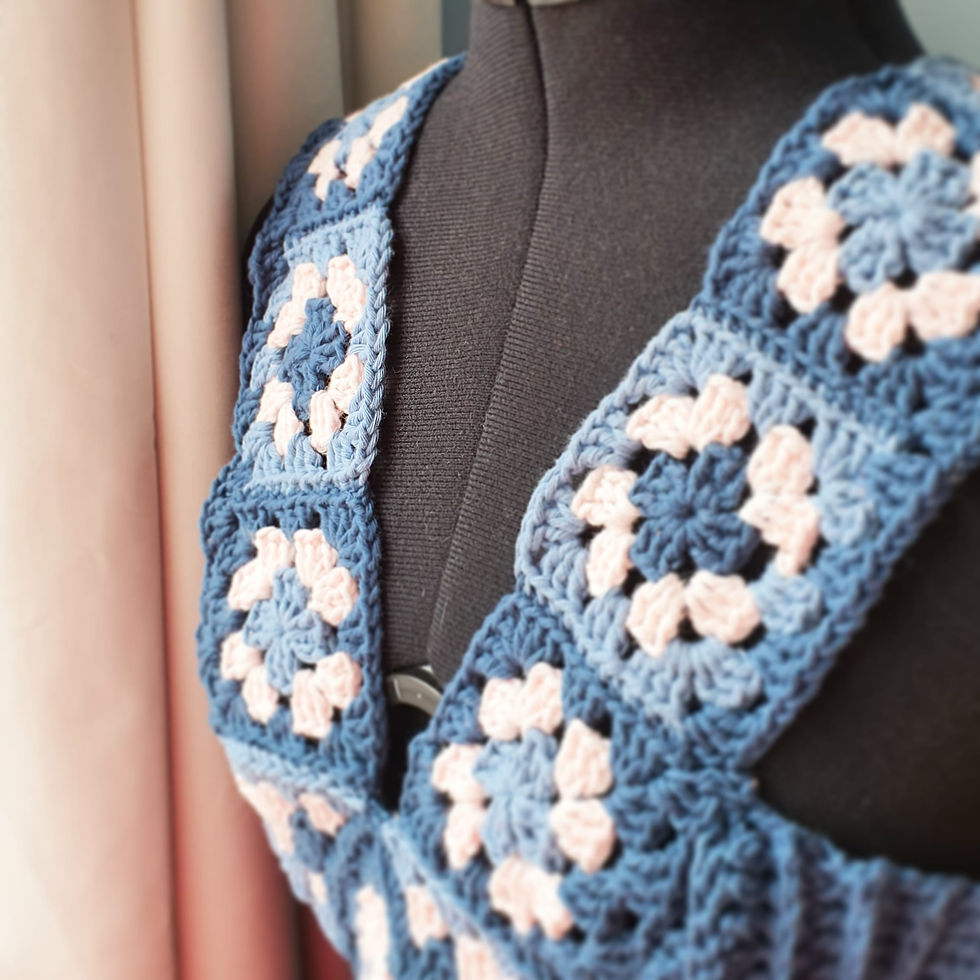 a denim blue crocheted bodice with Granny squares in blue and pink forming a V neck