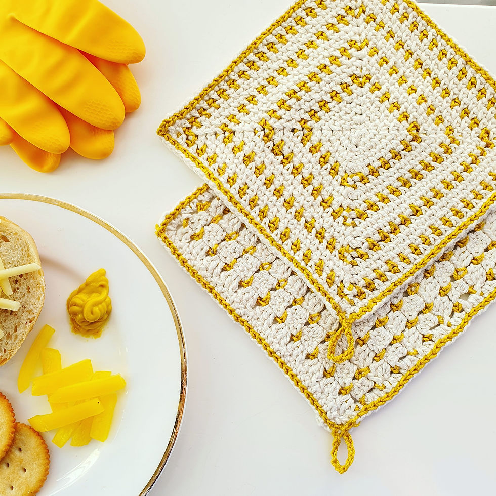 yellow and white crocheted cloths, plate and washing up gloves
