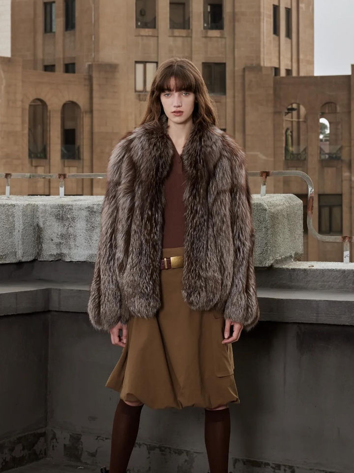 Model in brown faux fur coat and skirt