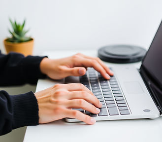 hands on keyboard with phone next to it.jpg