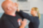 Student practicing a self defense strike on Instructor