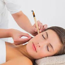 Thumbnail: Close‑up of a lit Hopi ear candle positioned in the ear