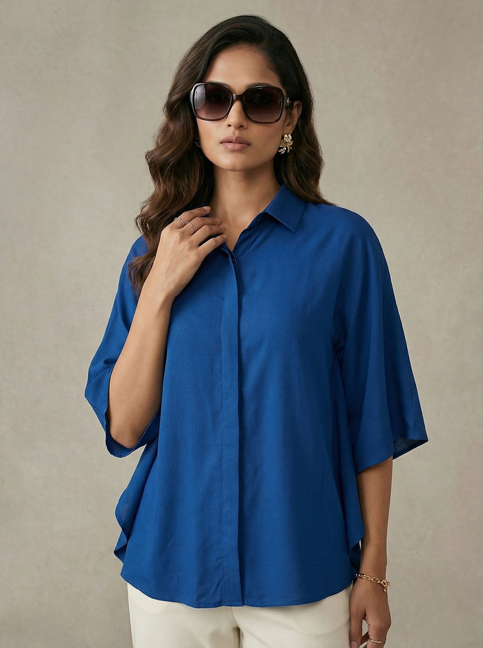 Model wearing Royal Blue Collared Kaftan Top with cream pants and heels