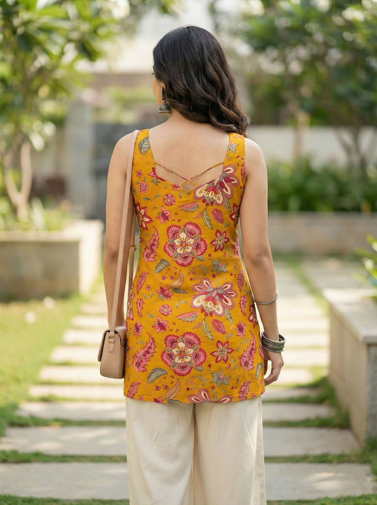 model wearing Mustard Floral Sleeveless Cotton Kurti Top