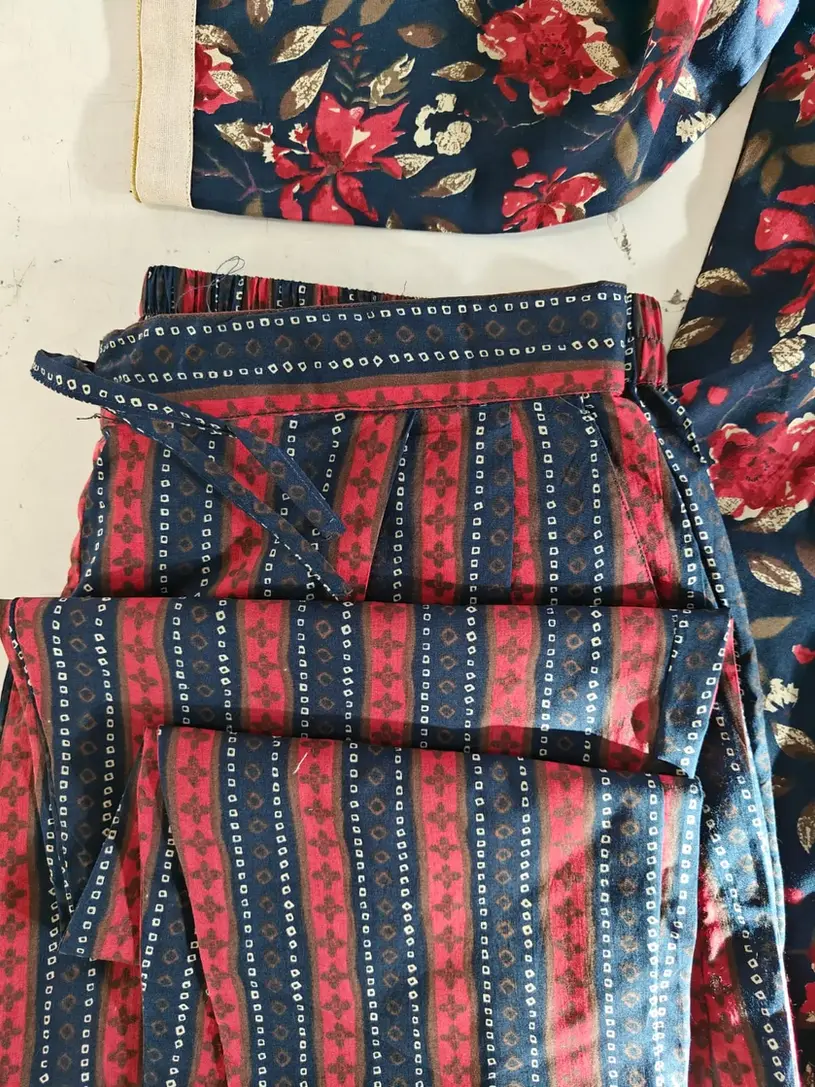 A kurti featuring custom latkan designs on the placket and personalized potli work on the dupatta.