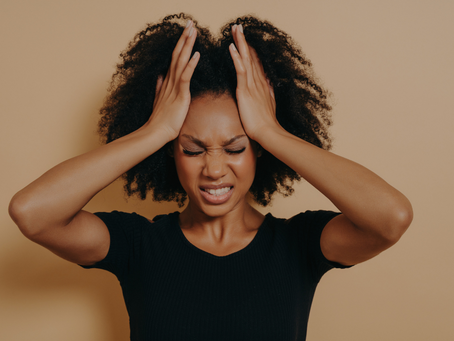 woman stressed out holding head