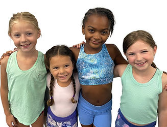 Four dancers standing together smiling