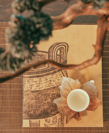 cup of tea on top of a traditional asian picture