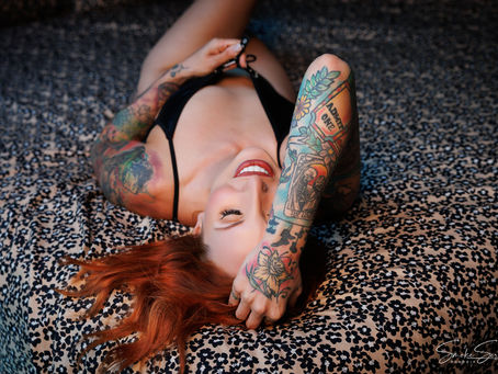 Woman smiling in black lingerie during a boudoir session in York PA