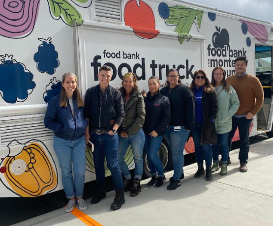 Picture of staff in front of the Regional Food Bank truck