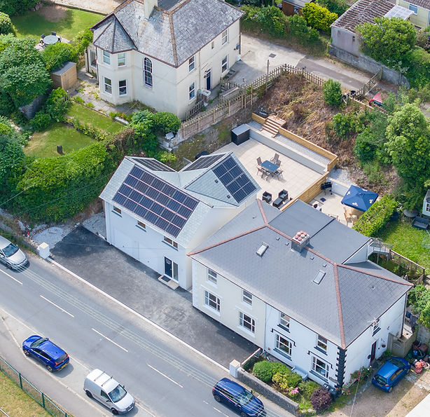 Front exterior view of both Le Dorney Villas, showcasing the charming period home and the modern eco-conscious villa side by side.