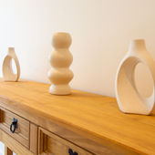 Close-up of tasteful ornaments on the entrance hall sideboard, adding a homely touch to Villa No. 3.