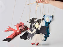 The marionettist working the puppet with the control bar