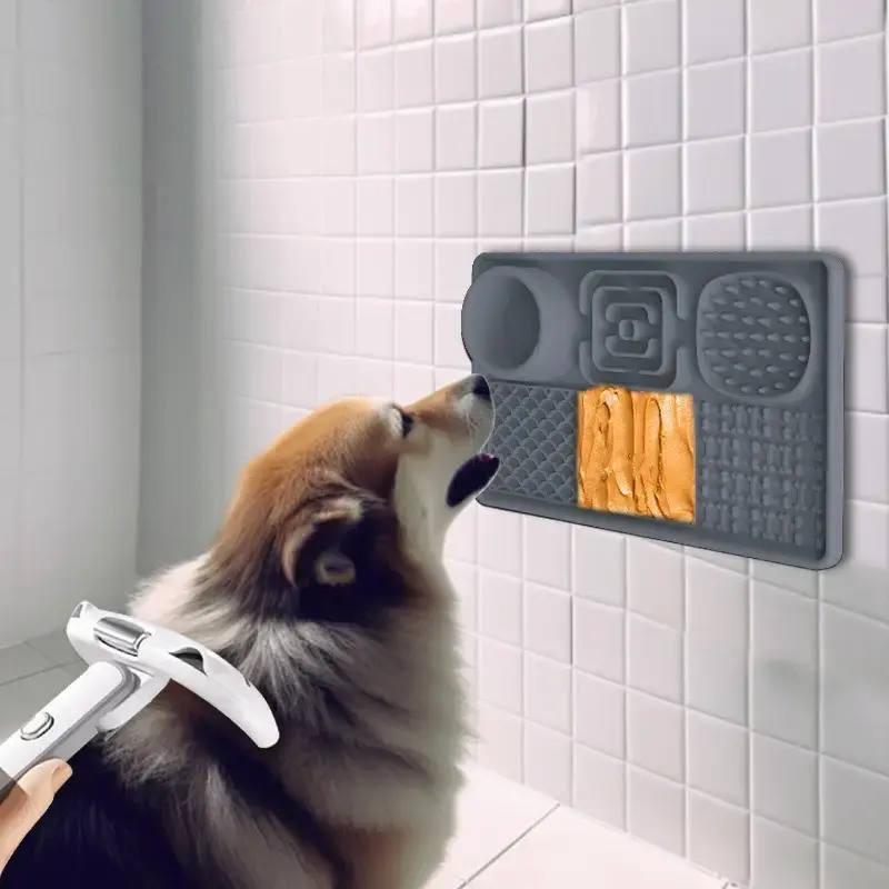 Grey multipurpose lick tray slow bowl on wall with dog licking it